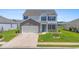 Charming two-story home with blue shutters and a well-manicured lawn at 2106 Ainsley Dr., Little River, SC 29566