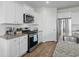 Bright kitchen features granite counters, stainless appliances, and open layout at 2106 Ainsley Dr., Little River, SC 29566