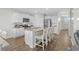 Spacious kitchen features a large island with seating, modern appliances, and white cabinets at 2106 Ainsley Dr., Little River, SC 29566