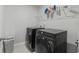 Modern laundry room featuring black front load washer and dryer and wire shelving at 2106 Ainsley Dr., Little River, SC 29566