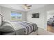 Bright bedroom with ceiling fan, wall-mounted TV, carpet, and a window with a pleasant neighborhood view at 2106 Ainsley Dr., Little River, SC 29566