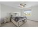 Comfortable bedroom with ceiling fan, carpet, and a window overlooking the neighborhood pond at 2106 Ainsley Dr., Little River, SC 29566