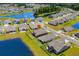 Aerial view of home with lake view, manicured lawn, black fence, and a serene residential neighborhood at 215 Kendrick St., Little River, SC 29566