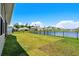 Expansive, well-maintained backyard with lush grass and a black fence bordering a tranquil lake at 215 Kendrick St., Little River, SC 29566
