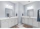 Bright bathroom featuring dual sinks, white cabinets, and elegant fixtures, creating a clean and functional space at 215 Kendrick St., Little River, SC 29566