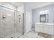 Modern bathroom with a glass-enclosed shower featuring white marble tile and a single sink vanity at 215 Kendrick St., Little River, SC 29566