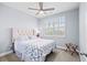 Bedroom with large window, ceiling fan, upholstered headboard and matching quilted bedspread at 215 Kendrick St., Little River, SC 29566