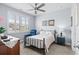 Cozy bedroom featuring a metal frame bed, a ceiling fan, and natural light from a large window at 215 Kendrick St., Little River, SC 29566