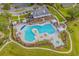Aerial view of a beautifully landscaped community pool, hot tub, and surrounding amenities at 215 Kendrick St., Little River, SC 29566