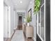 Inviting entryway featuring hardwood floors, a stylish console table, and a staircase leading to the upper level of the home at 215 Kendrick St., Little River, SC 29566