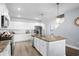 Spacious kitchen with white cabinetry, a center island with granite countertops, and stainless steel appliances, perfect for cooking at 215 Kendrick St., Little River, SC 29566