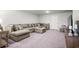 Spacious living room with a large sectional couch, neutral tones, and a table and chairs at 215 Kendrick St., Little River, SC 29566