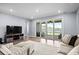 A spacious living room with sliding glass doors leading to a patio and offering views of the lake at 215 Kendrick St., Little River, SC 29566