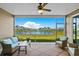 Inviting screened porch featuring comfortable seating and serene views of the lake and manicured lawns at 215 Kendrick St., Little River, SC 29566