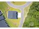 Aerial view of the house showing roof, lawn, proximity to the road and tree line at 215 Vivian St. Nw # 215, Calabash, NC 28467