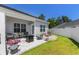 Landscaped backyard featuring stone patio, outdoor seating, and lush green lawn at 215 Vivian St. Nw # 215, Calabash, NC 28467