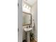 Charming powder room with pedestal sink, decorative mirror, and stylish lighting fixtures at 215 Vivian St. Nw # 215, Calabash, NC 28467