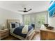 Bright bedroom with a ceiling fan, large windows, and wooden furniture creates a relaxing retreat at 215 Vivian St. Nw # 215, Calabash, NC 28467