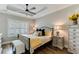 Serene bedroom with tray ceiling, ceiling fan, and a comfortable bed with decorative pillows and side tables at 215 Vivian St. Nw # 215, Calabash, NC 28467