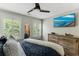 Bedroom with large windows for natural light and wooden dresser and a ceiling fan at 215 Vivian St. Nw # 215, Calabash, NC 28467