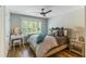 Cozy bedroom features unique furniture, decor, a ceiling fan, and an abundance of natural light at 215 Vivian St. Nw # 215, Calabash, NC 28467
