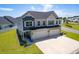 Two-story home with a two-car garage, covered porch, manicured lawn, and neutral color palette at 215 Vivian St. Nw # 215, Calabash, NC 28467