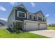 Charming exterior view of a two-story home with a two-car garage and well-maintained landscaping at 215 Vivian St. Nw # 215, Calabash, NC 28467