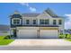 Beautiful two-story home featuring a two-car garage and manicured lawn under a clear blue sky at 215 Vivian St. Nw # 215, Calabash, NC 28467