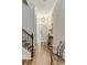 Bright foyer with hardwood floors, a staircase, and a decorative table showcasing a welcoming entrance at 215 Vivian St. Nw # 215, Calabash, NC 28467