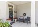 Inviting front porch with decorative chairs, wreaths, and potted flowers creating a cozy entrance at 215 Vivian St. Nw # 215, Calabash, NC 28467