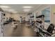 On-site fitness center with various weight training machines and large window with a pool view at 215 Vivian St. Nw # 215, Calabash, NC 28467