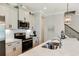 Contemporary kitchen with stainless steel appliances, white cabinets, and a view of the staircase at 215 Vivian St. Nw # 215, Calabash, NC 28467