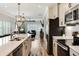 Stylish kitchen with stainless steel appliances, white cabinets, and an open view into the living room at 215 Vivian St. Nw # 215, Calabash, NC 28467
