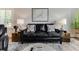 Comfortable living room featuring a black leather sofa, stylish lamps, and a decorative map on the wall at 215 Vivian St. Nw # 215, Calabash, NC 28467
