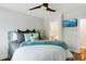 Main bedroom boasting a ceiling fan, soft decor, and an ensuite bathroom at 215 Vivian St. Nw # 215, Calabash, NC 28467