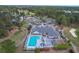 Aerial shot of the pool and clubhouse with mature trees, parking, and well manicured lawns at 215 Vivian St. Nw # 215, Calabash, NC 28467
