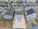 An aerial view of a raised waterfront home featuring parking, canal access and charming exterior at 25 Newport St., Ocean Isle Beach, NC 28469