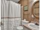 Bathroom featuring wood paneled wall, toilet, sink and vanity, and white shower curtain with frills at 25 Newport St., Ocean Isle Beach, NC 28469