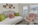 Cozy bedroom featuring a decorative daybed, a rocking chair, and bright pillows, creating a comfortable and inviting space at 25 Newport St., Ocean Isle Beach, NC 28469