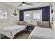 Charming bedroom featuring two twin beds, nautical decor, and ample natural light from window with white shutters at 25 Newport St., Ocean Isle Beach, NC 28469