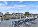 A waterfront deck featuring lounge chairs and a table, perfect for relaxing and enjoying the view at 25 Newport St., Ocean Isle Beach, NC 28469