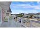 Spacious deck with white railings overlooking a neighborhood, offering an ideal spot for outdoor relaxation at 25 Newport St., Ocean Isle Beach, NC 28469