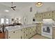 Open concept kitchen with vintage cabinets and a large island, perfect for entertaining guests at 25 Newport St., Ocean Isle Beach, NC 28469