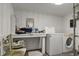 Functional laundry room featuring modern washer and dryer, ample counter space, and storage solutions for convenience at 25 Newport St., Ocean Isle Beach, NC 28469
