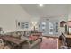 Bright living room with a plush sectional sofa, modern décor, and access to outdoor balcony at 25 Newport St., Ocean Isle Beach, NC 28469