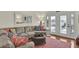 Inviting living room with a plush sectional sofa, mirrored wall decor, and a walkout balcony at 25 Newport St., Ocean Isle Beach, NC 28469