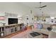 Comfortable living room with hardwood floors, a sofa, a ceiling fan, and views into kitchen at 25 Newport St., Ocean Isle Beach, NC 28469