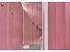 Outdoor shower with pink paneling, offering a convenient and private space to rinse off after enjoying outdoor activities at 25 Newport St., Ocean Isle Beach, NC 28469