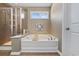 Well-lit bathroom featuring a soaking tub, glass shower, and tiled floor at 2709 Eton St., Myrtle Beach, SC 29579