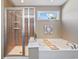 Bright bathroom with a soaking tub, glass shower, and a sunny window at 2709 Eton St., Myrtle Beach, SC 29579